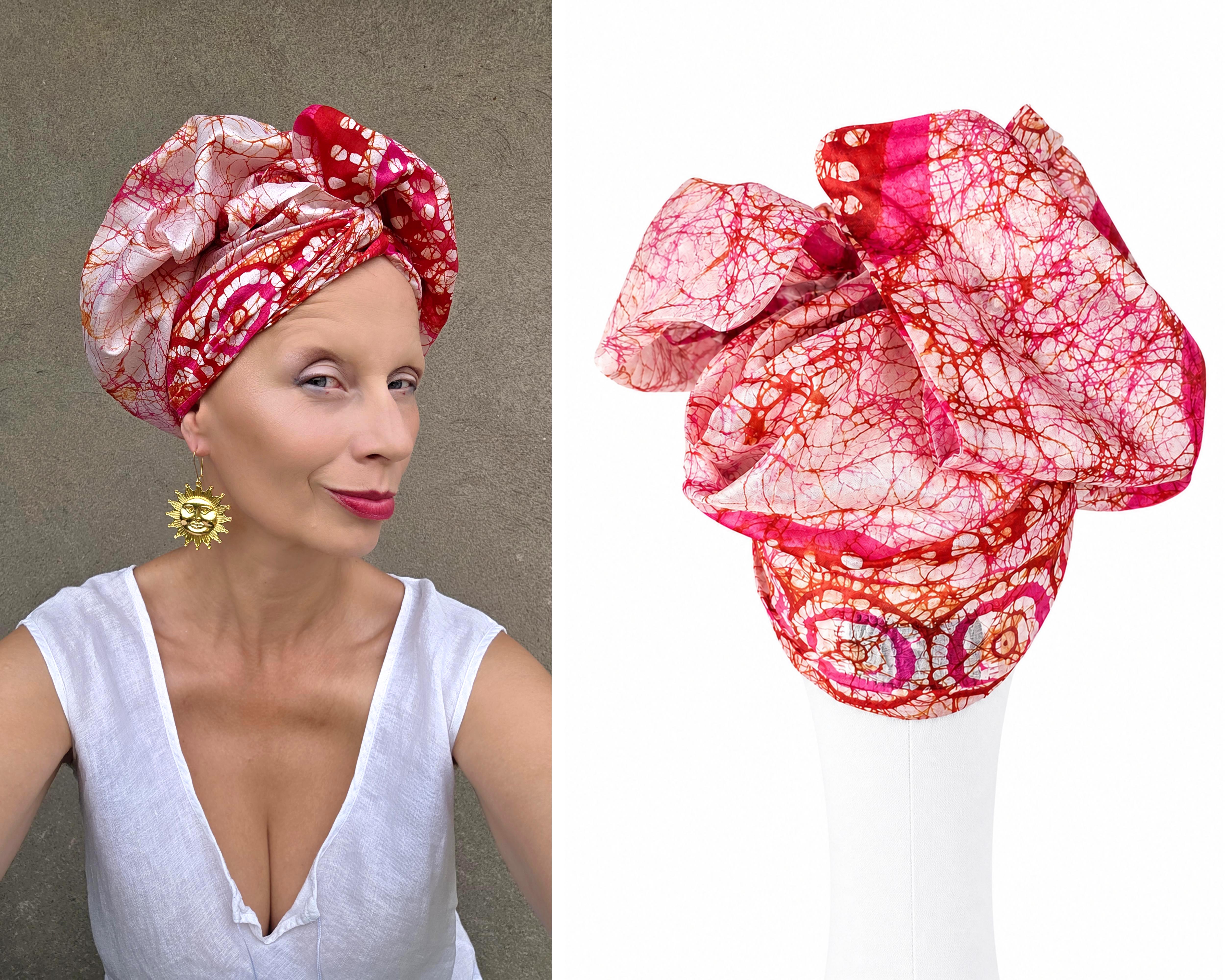 Red and pink silk turban for women by GLINKOWSKA styled on a woman