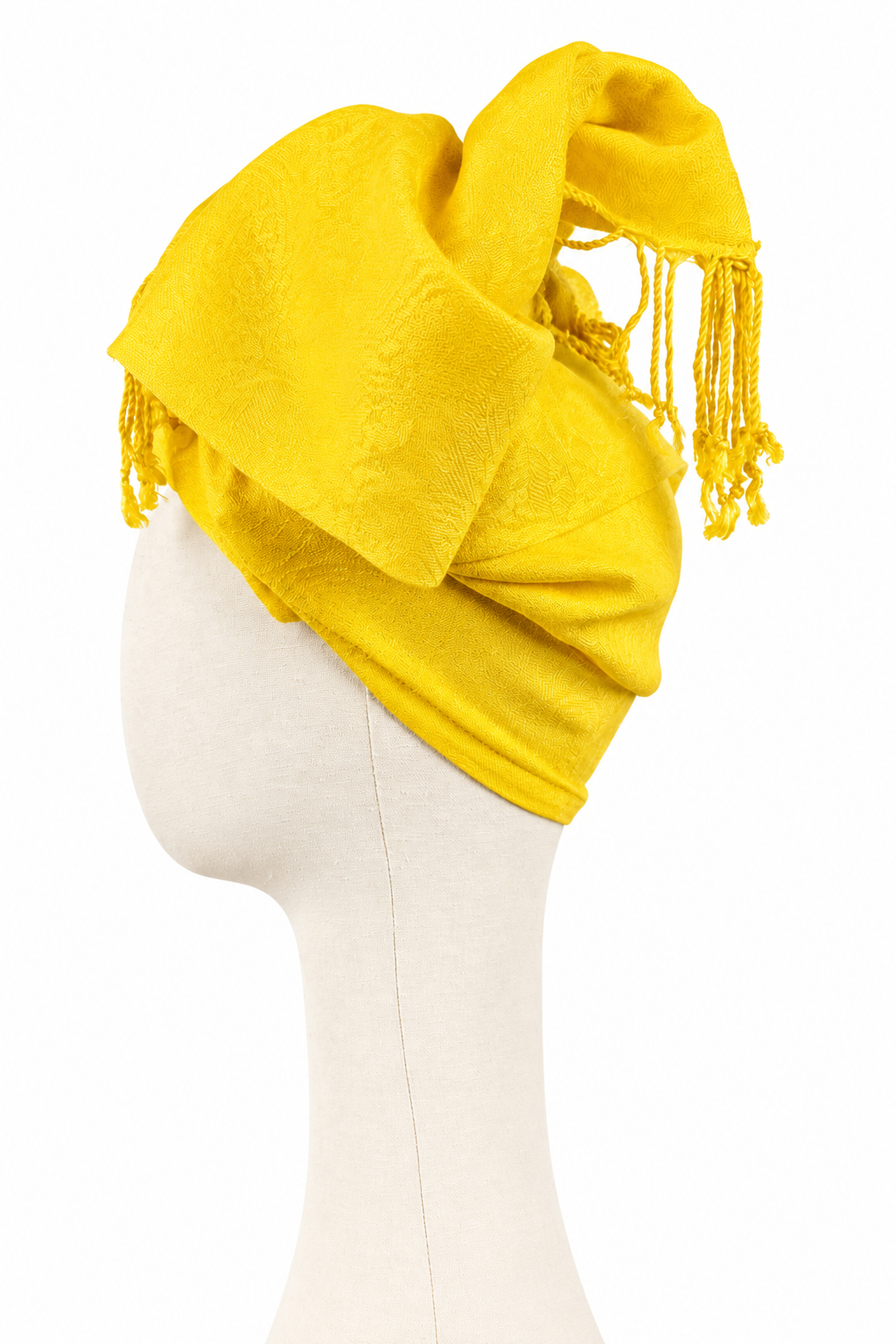 Yellow jacquard twist turban with textured fabric and fringes, shown from the opposite side.