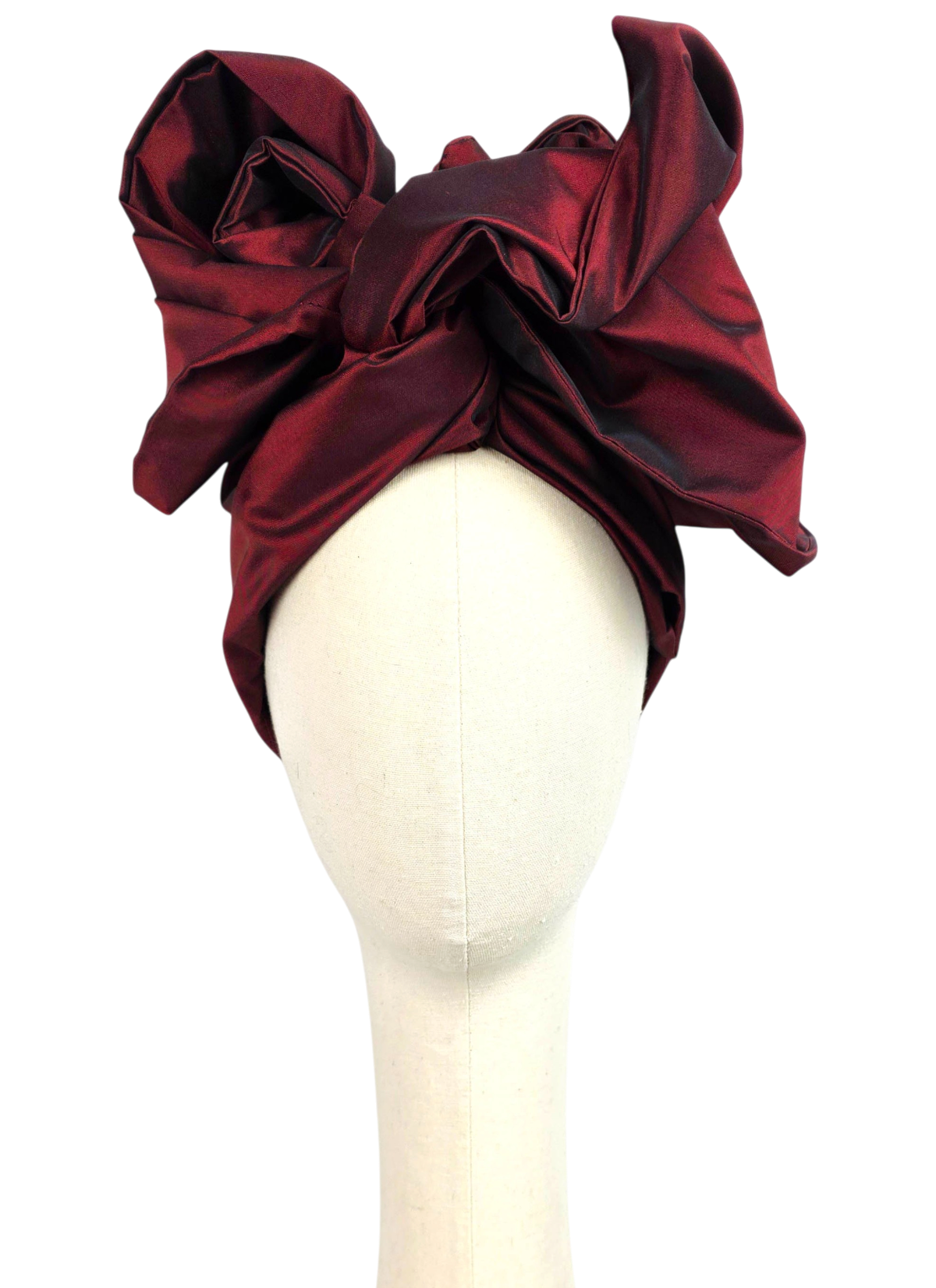 Front view of a women’s long burgundy taffeta Twist evening turban with sculptural folded panels.