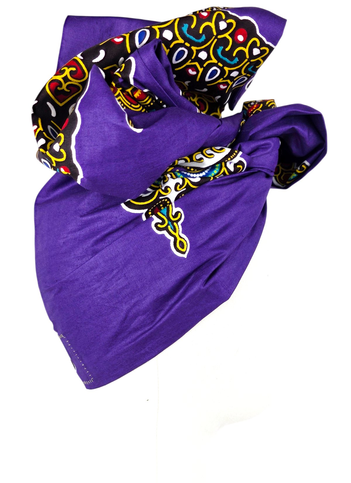 Side view of a purple cotton turban with a black ornamental band and a large bow on top, on a mannequin.