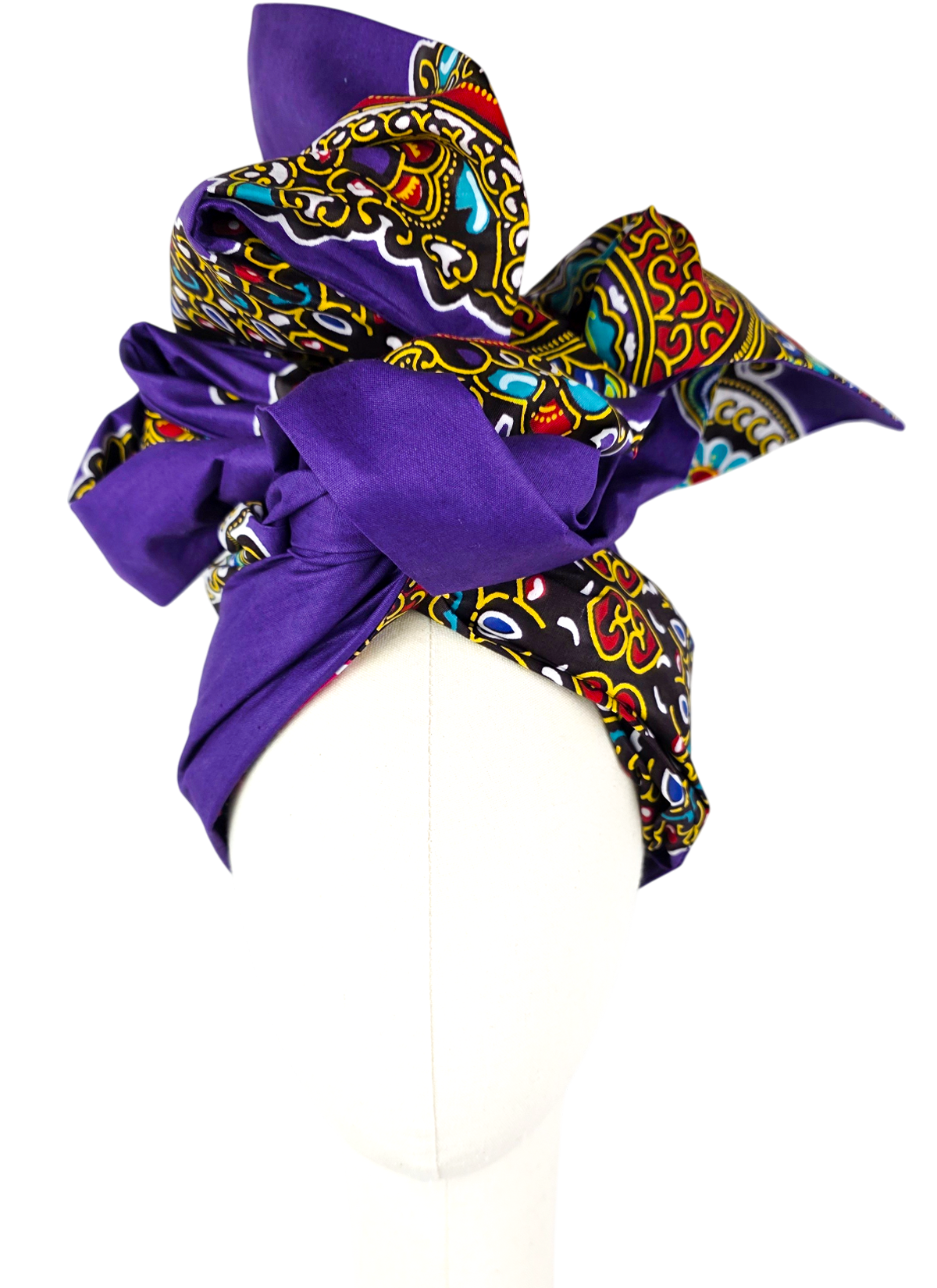 Purple Twist Long turban of African print cotton with a multicolor ornament and a high bow, front view on a mannequin, for spring, summer and fall.